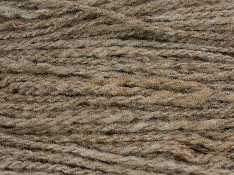 Strands of Burl, a bulky and fawn colored yarn produced by Gothfarm Yarn and made from Shetland wool and alpaca fleece.